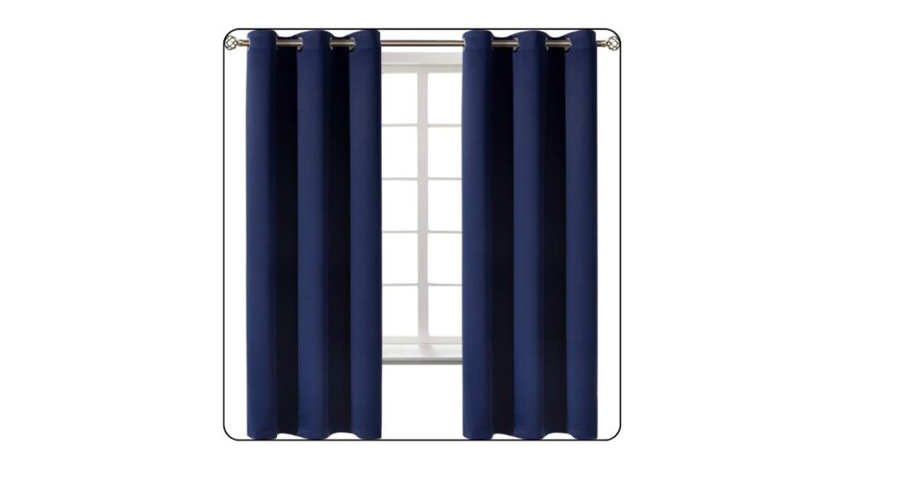Navy blue blackout curtains creating a cozy and elegant luxury bedroom atmosphere.